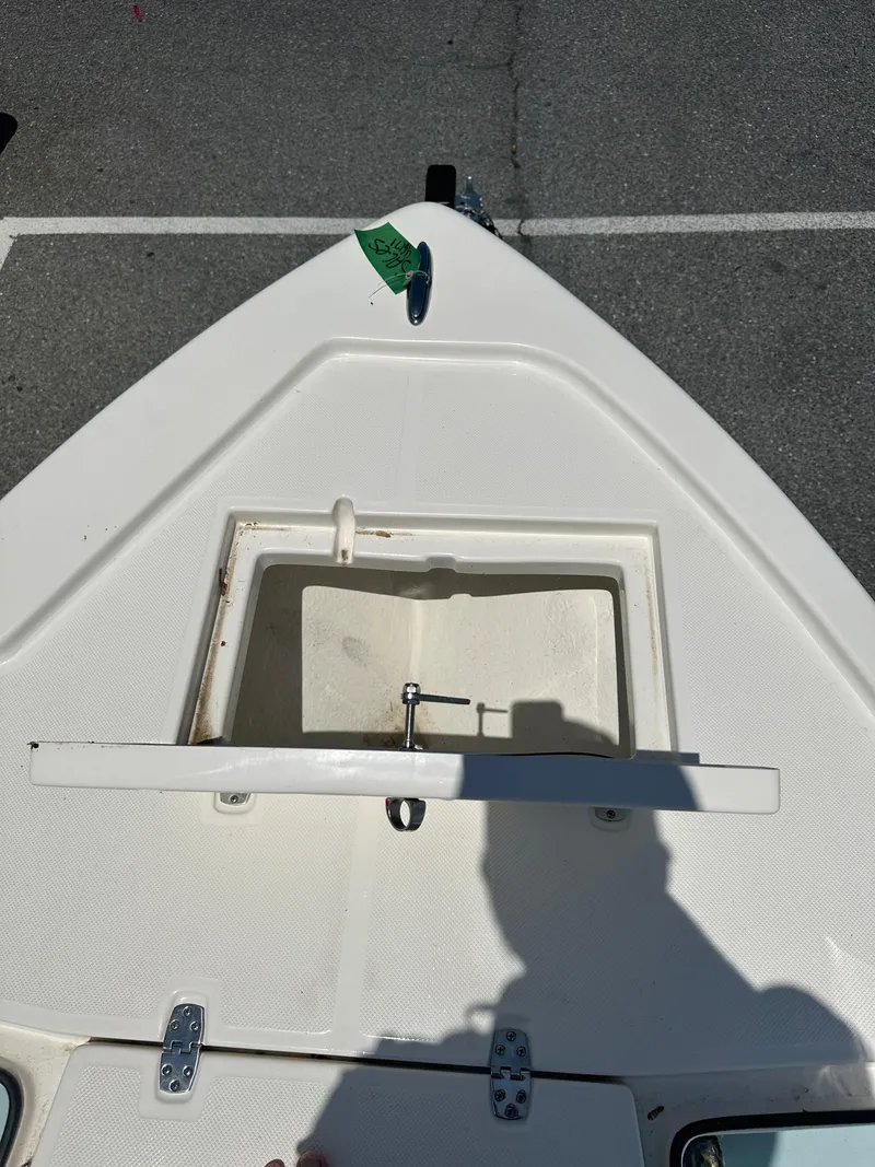 Slide: The Image of 2024 Sea Born FX21 Bay LT boat bow with open storage compartment. - 11