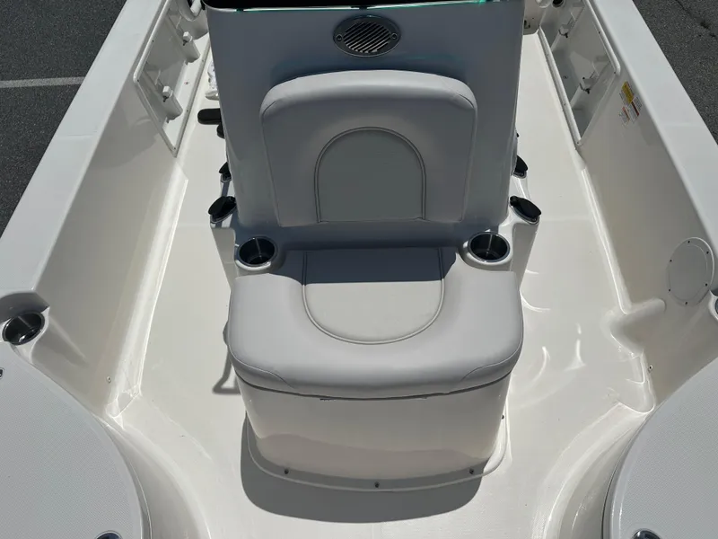 Slide: The Image of 2024 Sea Born FX21 Bay LT boat interior with cushioned seating and cup holders. - 13