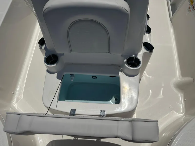 Slide: The Image of 2024 Sea Born FX21 Bay LT boat with open storage compartment and cup holders. - 14