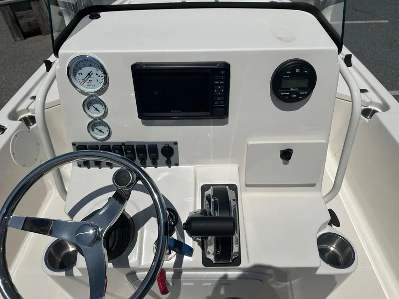 Slide: The Image of 2024 Sea Born FX21 Bay LT boat console with steering wheel, gauges, and controls. - 18