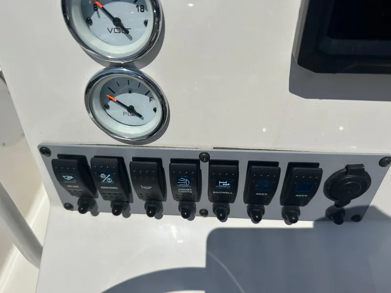 Slide: The Image of Control panel of 2024 Sea Born FX21 Bay LT boat with gauges and switches. - 19