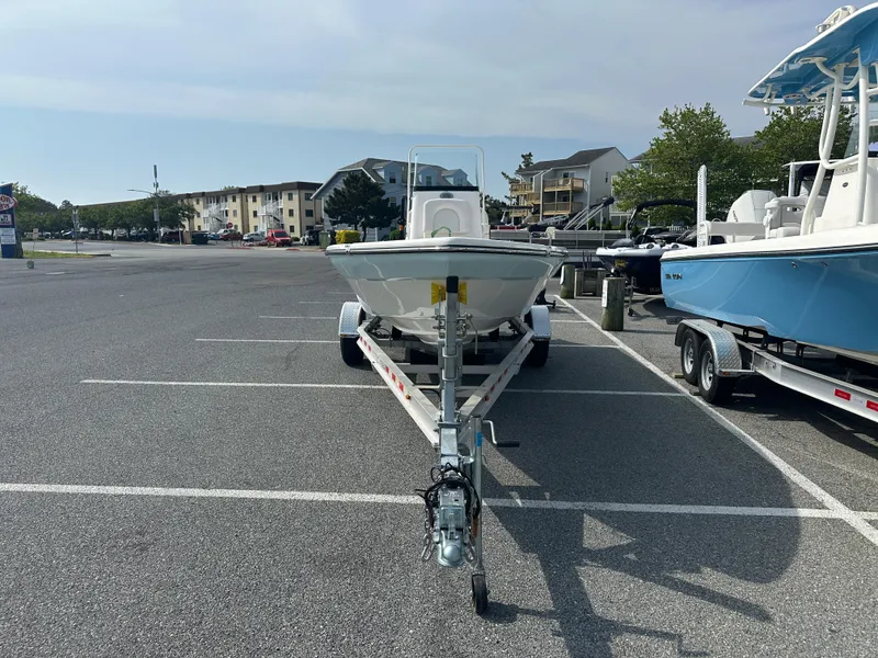 Slide: The Image of 2024 Sea Born FX21 Bay LT boat on trailer in parking lot. - 2