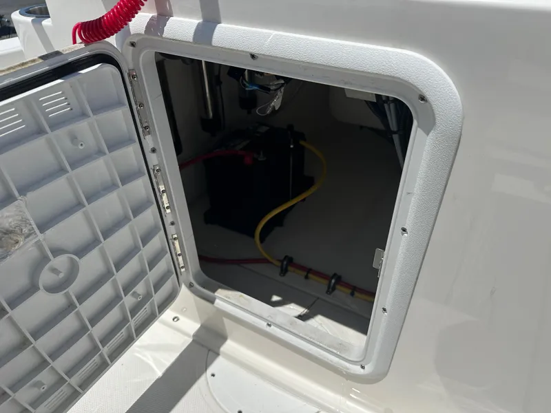Slide: The Image of 2024 Sea Born FX21 Bay LT boat battery compartment with wiring. - 24