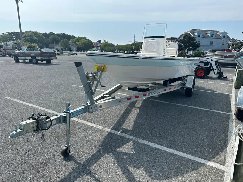 Slide: The Image of 2024 Sea Born FX21 Bay LT boat on a trailer in a parking lot. - 3
