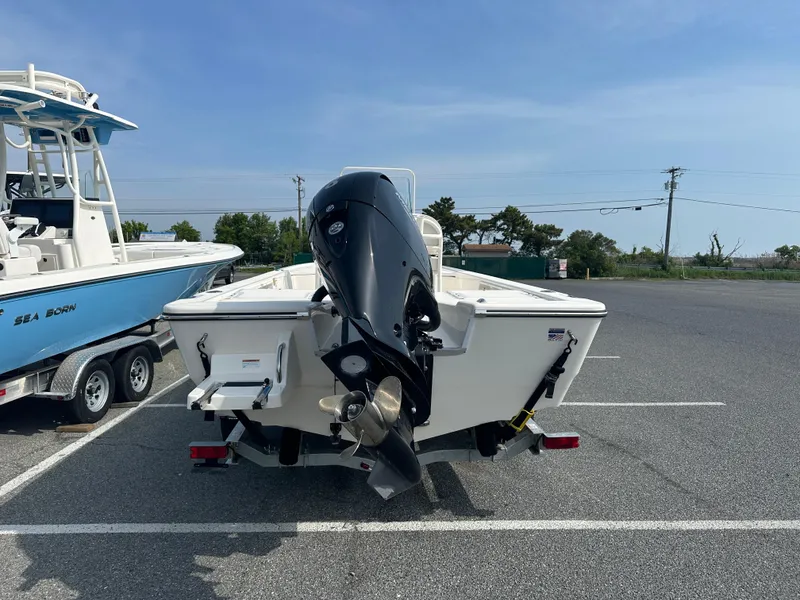 Slide: The Image of 2024 Sea Born FX21 Bay LT boat with outboard motor in parking lot. - 32