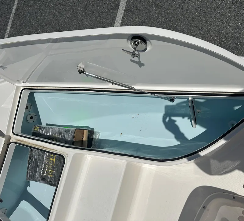 Slide: The Image of 2024 Sea Born FX21 Bay LT boat storage compartment with open hatch. - 8