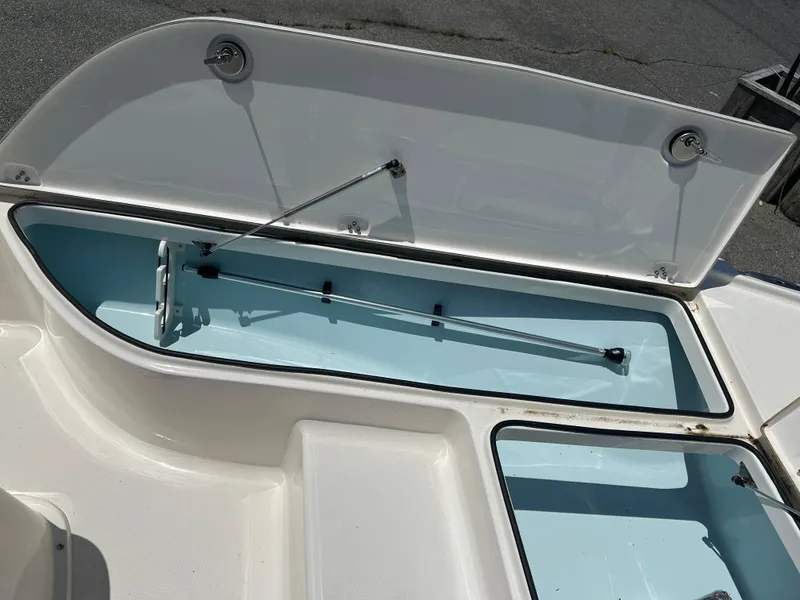 Slide: The Image of 2024 Sea Born FX21 Bay LT boat storage compartment open. - 9