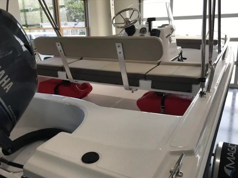 Slide: The Image of 2025 Edgewater 158 CS boat interior with Yamaha engine and seating. - 11