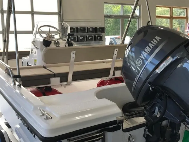 Slide: The Image of 2025 Edgewater 158 CS boat with Yamaha outboard motor in showroom. - 14