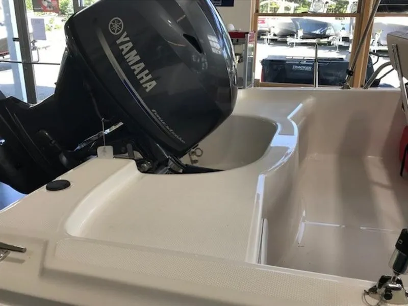 Slide: The Image of 2025 Edgewater 158 CS boat with Yamaha outboard motor in showroom. - 7