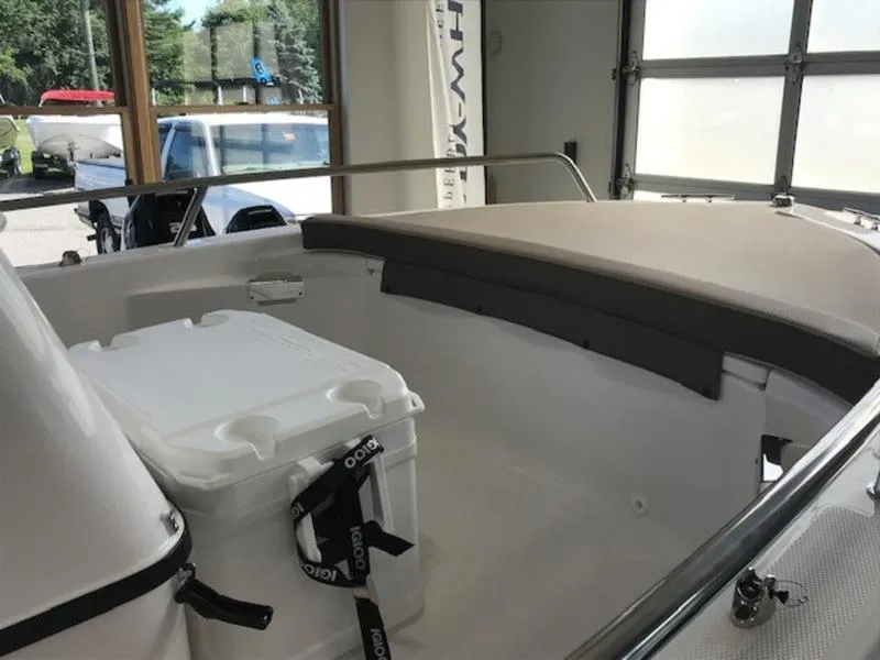 Slide: The Image of 2025 Edgewater 158 CS boat interior with seating and cooler. - 8