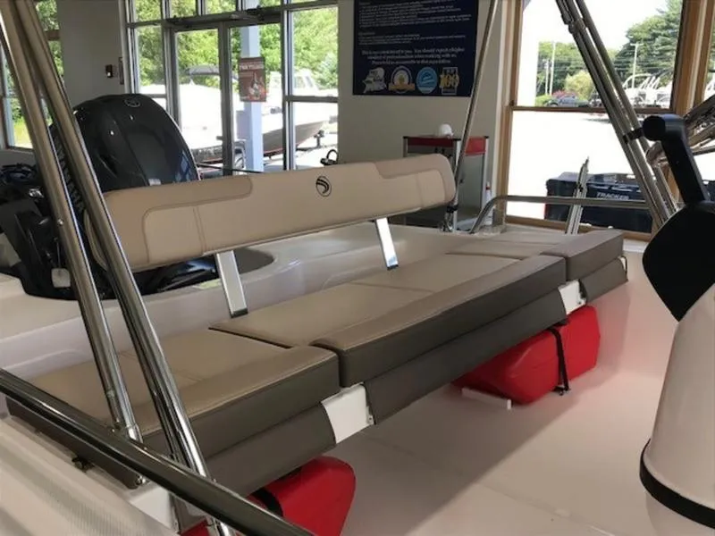 Slide: The Image of 2025 Edgewater 158 CS boat interior with cushioned seating and red storage compartments. - 9