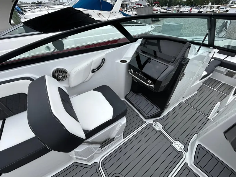 Slide: The Image of Interior of a 2021 Monterey M65 boat with modern seating and control panel. - 12