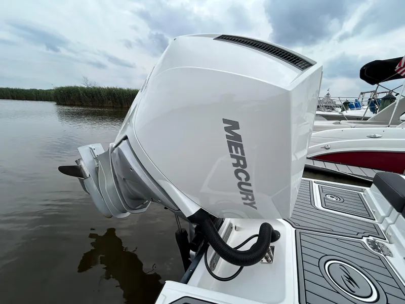 Slide: The Image of 2021 Monterey M65 boat with Mercury outboard motor on a calm lake. - 14