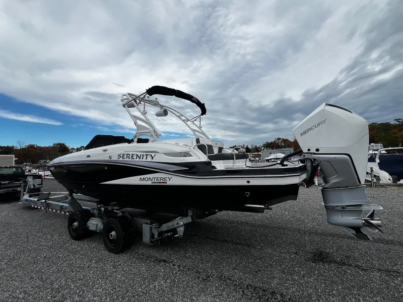 Slide: The Image of 2021 Monterey M65 boat on trailer, featuring a powerful outboard motor. - 3