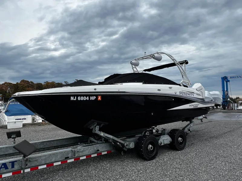 Slide: The Image of 2021 Monterey M65 boat named Serenity on a trailer in a marina. - 4