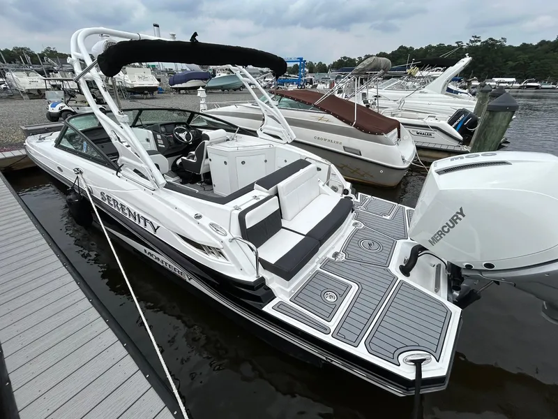 Slide: The Image of 2021 Monterey M65 boat docked at marina with Mercury outboard engine. - 8