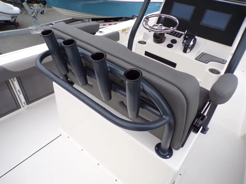 Slide: The Image of 2024 Sea Born LX24 Center Console LE boat helm with rod holders and navigation controls. - 11