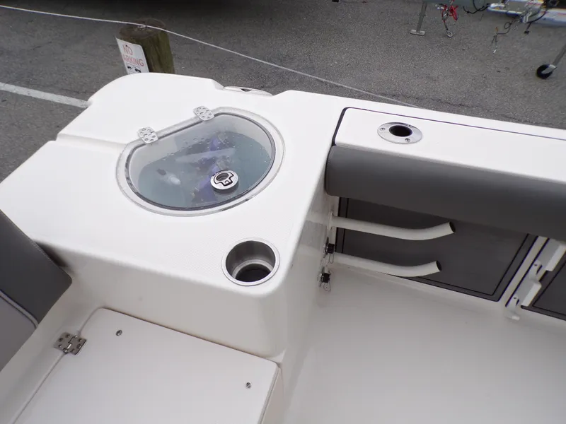 Slide: The Image of 2024 Sea Born LX24 Center Console LE boat interior detail with livewell and storage compartments. - 12