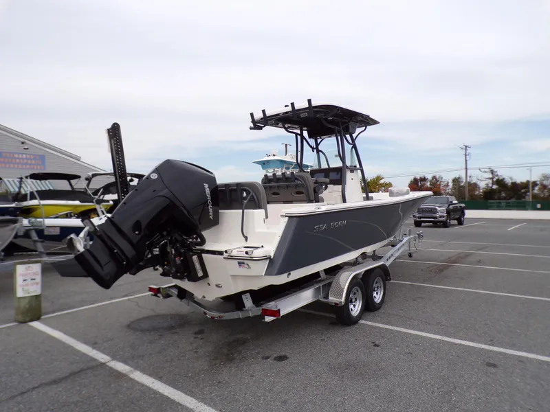 Slide: The Image of 2024 Sea Born LX24 Center Console LE boat on a trailer in a parking lot. - 5