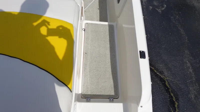 Slide: The Image of 2002 Rinker 212 Captiva Bowrider interior with yellow and white upholstery. - 6