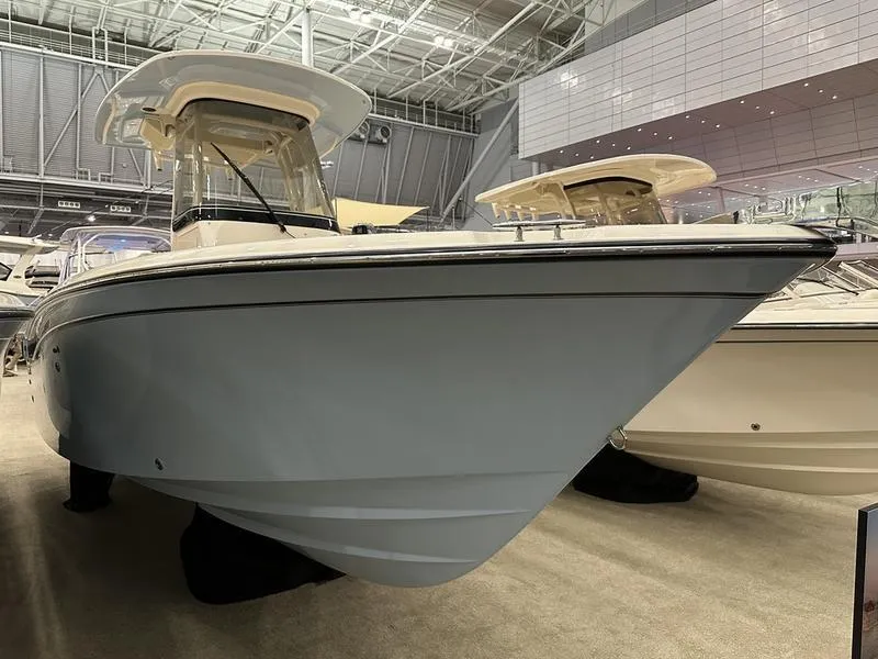 The Image of 2025 Grady-White Fisherman 257 boat displayed indoors at a showroom. - 1