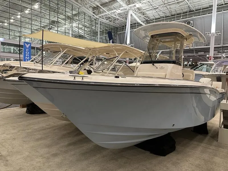 Slide: The Image of 2025 Grady-White Fisherman 257 boat displayed in a showroom, showcasing sleek design and modern features. - 4