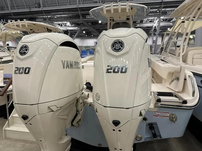 Slide: The Image of 2025 Grady-White Fisherman 257 with twin Yamaha 200 engines at a boat show. - 5