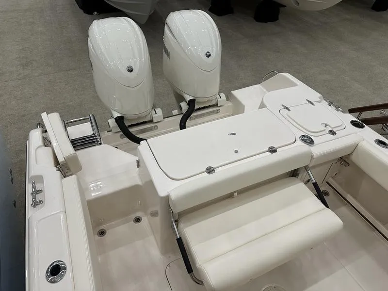 Slide: The Image of 2025 Grady-White Fisherman 257 boat with dual outboard engines, rear seating, and storage compartments. - 6