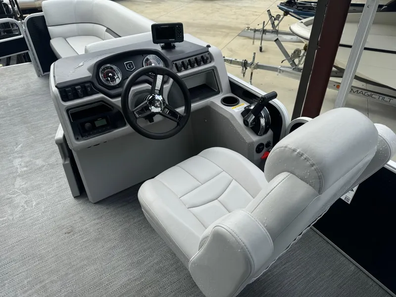 Slide: The Image of 2023 Godfrey 2286 boat interior with captain's chair and control console. - 10