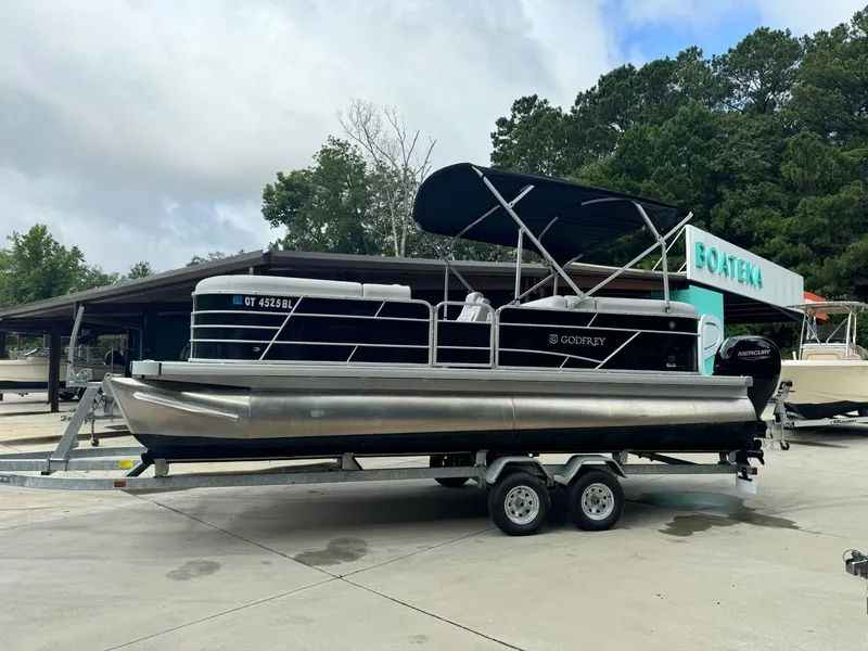 Slide: The Image of 2023 Godfrey 2286 pontoon boat on a trailer at Boateka dealership. - 4