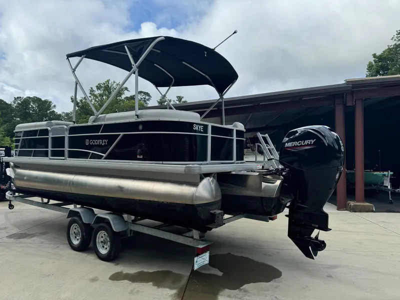 Slide: The Image of 2023 Godfrey 2286 pontoon boat with Mercury outboard motor on trailer. - 5
