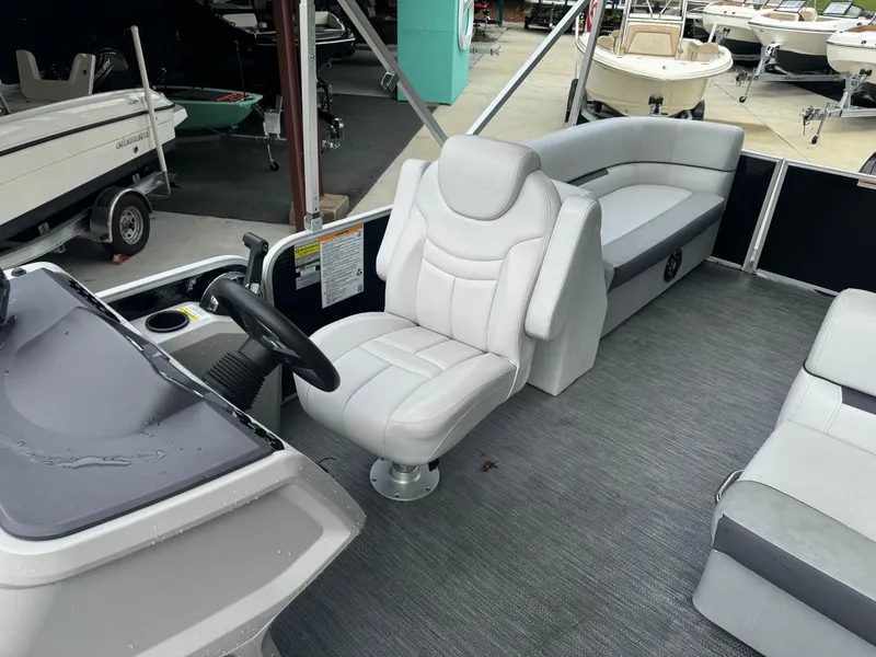 Slide: The Image of 2023 Godfrey 2286 boat interior with captain's chair and seating area. - 9