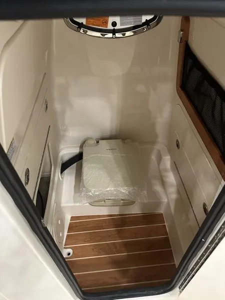 Slide: The Image of 2025 Grady-White Fisherman 236 boat interior with storage and wooden flooring. - 11