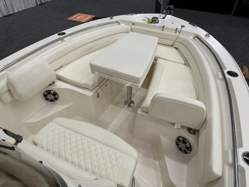 Slide: The Image of 2025 Grady-White Fisherman 236 boat interior with cushioned seating and table. - 14