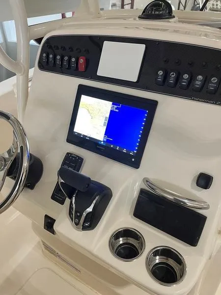 Slide: The Image of 2025 Grady-White Fisherman 236 dashboard with navigation system and controls. - 16