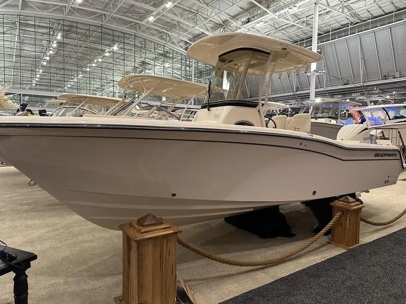 Slide: The Image of 2025 Grady-White Fisherman 236 boat displayed in an indoor showroom. - 2