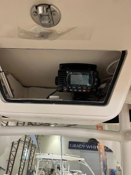 Slide: The Image of 2025 Grady-White Fisherman 236 boat interior with electronic equipment in storage compartment. - 3
