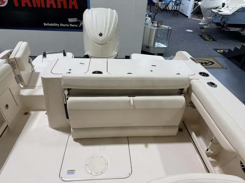 Slide: The Image of 2025 Grady-White Freedom 235 boat interior with seating and engine view. - 10