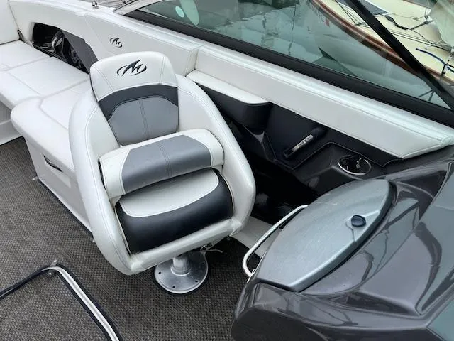 Slide: The Image of 2014 Monterey 268 Super Sport boat interior with captain's chair and dashboard. - 6