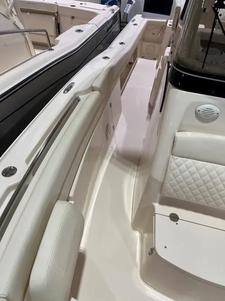 Slide: The Image of 2025 Grady-White CAYNON 271 boat interior with white seating and sleek design. - 10