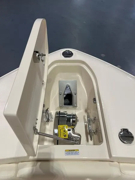 Slide: The Image of 2025 Grady-White CAYNON 271 boat anchor compartment with open hatch. - 12