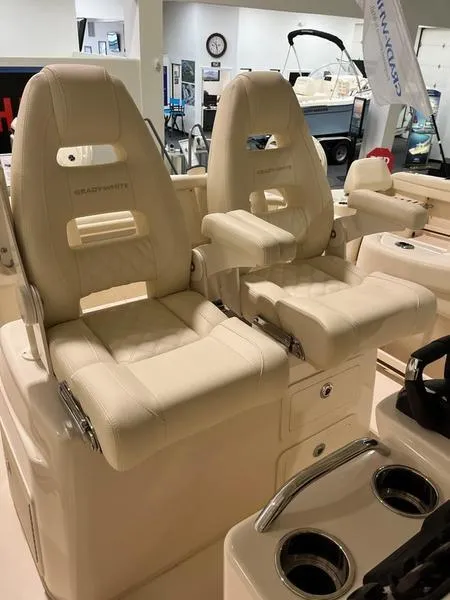 Slide: The Image of 2025 Grady-White CAYNON 271 boat seats, luxurious design, beige upholstery, showroom display. - 13