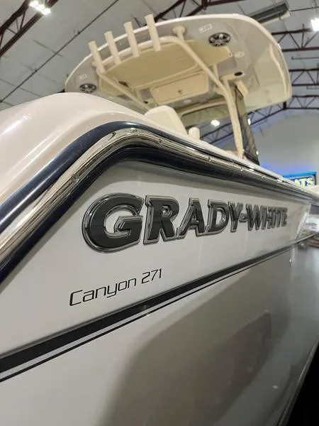 Slide: The Image of 2025 Grady-White Canyon 271 boat in showroom, side view. - 3