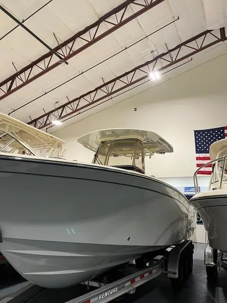 Slide: The Image of 2025 Grady-White CAYNON 271 boat in showroom, on trailer, with American flag. - 5