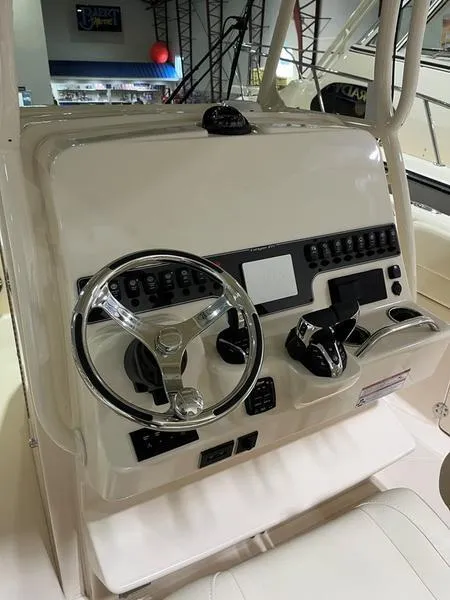 Slide: The Image of 2025 Grady-White CAYNON 271 boat dashboard with steering wheel and controls. - 8