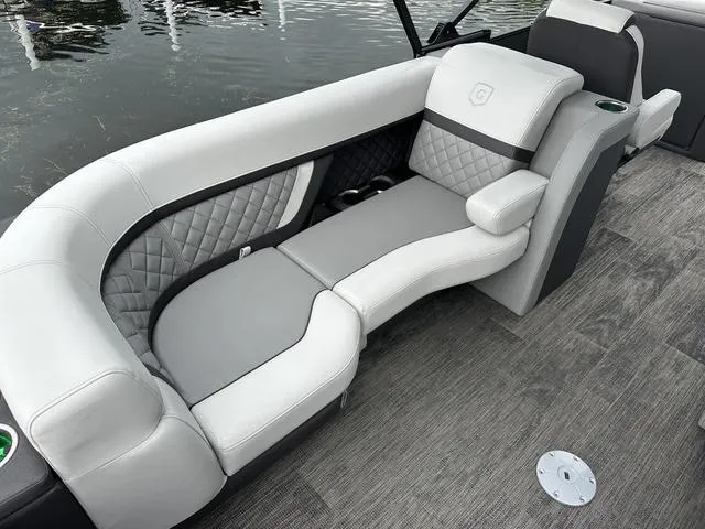 Slide: The Image of Luxurious interior of 2025 Godfrey AP 255 SBC boat with plush seating and cup holders. - 13