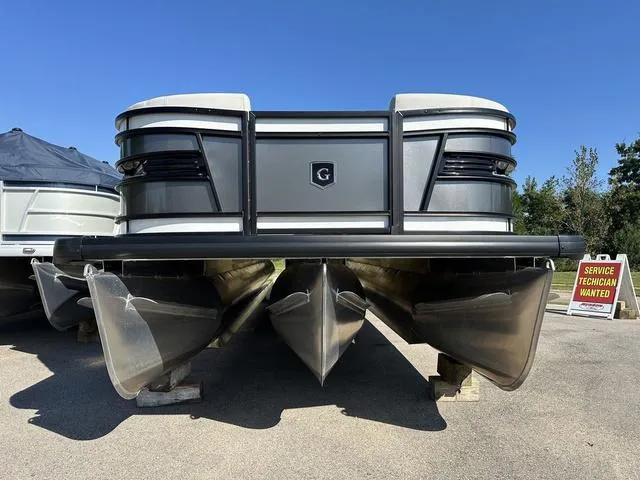 Slide: The Image of 2025 Godfrey AP 255 SBC boat interior with cup holders and control panel. - 21