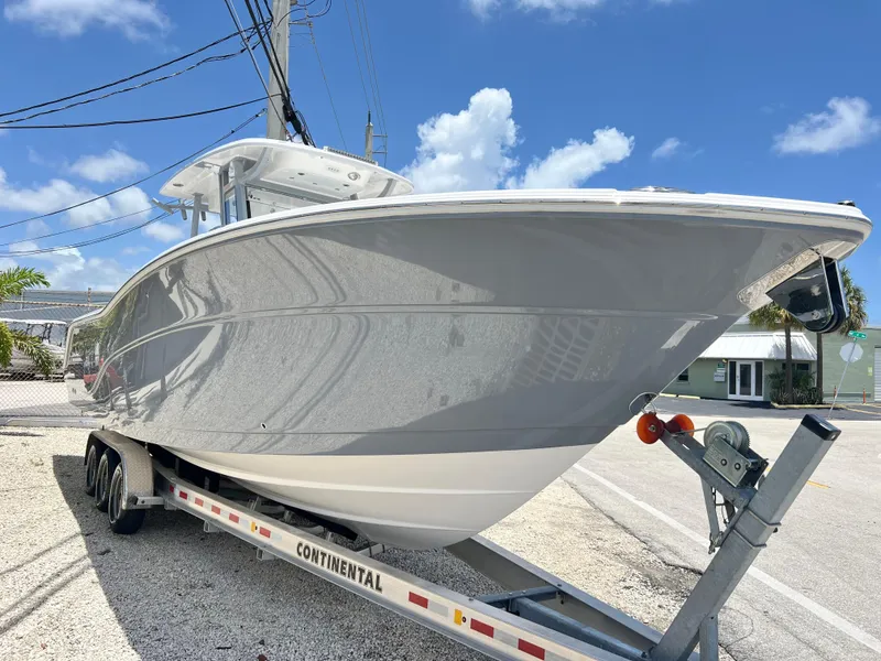 Slide: The Image of 2025 Sea Fox 328 Commander boat on a Continental trailer under a clear blue sky. - 12