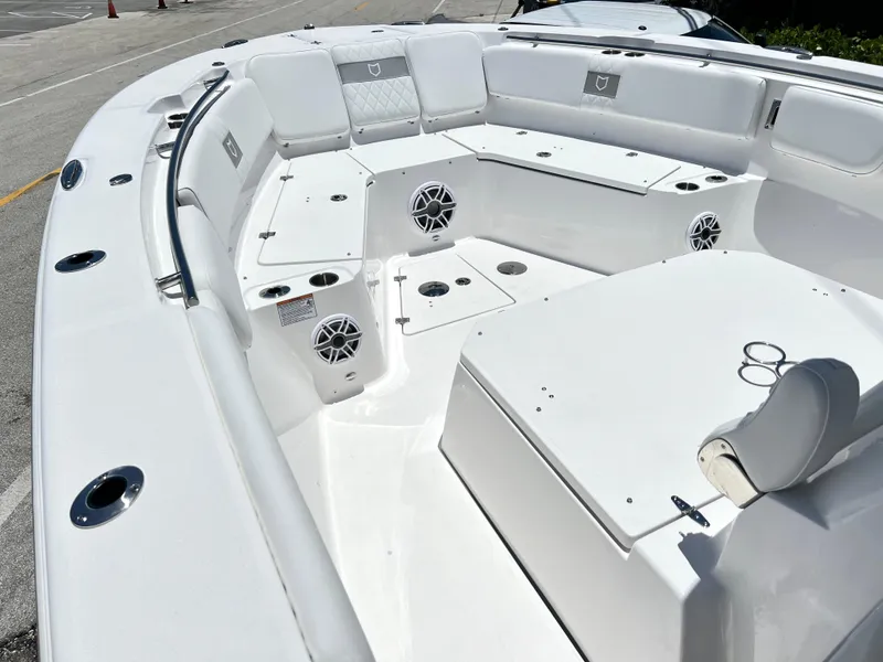 Slide: The Image of 2025 Sea Fox 328 Commander boat interior with white seating and storage compartments. - 13